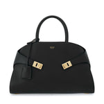 Black handbag with gold hardware on a white background