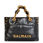 Black handbag with gold chain handle and 'Balmain' branding on a white background