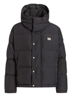 Black puffer jacket with a brand logo on a white background