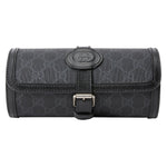 Black Gucci toiletry bag with monogram pattern on a light gray background