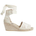 White wedge sandal with espadrille sole on a light gray background