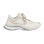 White sneaker with chain detail on a light gray background