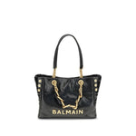 Black handbag with gold chain and 'Balmain' branding on a white background