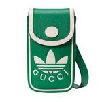 Green crossbody bag with white Gucci logo on a light gray background