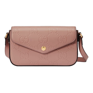 Pink handbag with gold accents on a light gray background