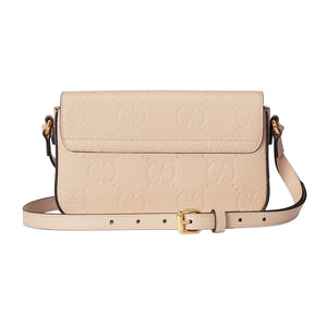Beige handbag with gold accents on a light gray background