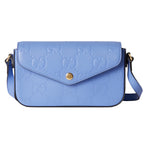 Blue handbag with gold accents on a light gray background