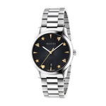Gucci watch with black dial and silver bracelet on a light gray background