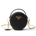 Black Prada handbag with gold chain on a white background