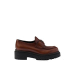 Brown leather shoe with thick black sole on a white background