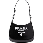 Black Prada handbag with white logo on a light gray background