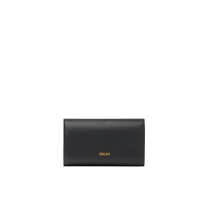 Black Versace wallet on a light gray background