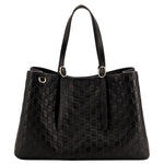 Black quilted handbag on a light gray background