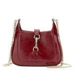 Red handbag with gold chain strap on a white background