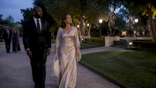 Luxury shopper escorted by security guard outdoors