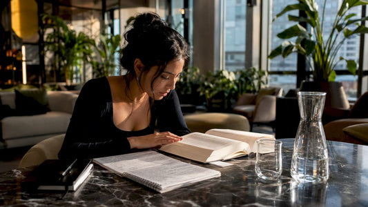 Person studying luxury fashion terminology at home desk