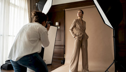 Fashion photographer adjusting studio lights