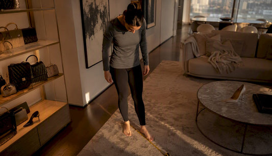 Person measuring foot length with ruler
