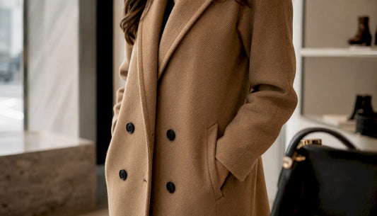 Close-up of camel designer coat and handbag detail