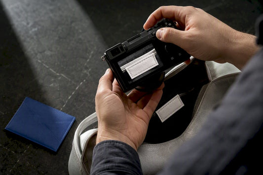 Photographer capturing handbag interior tag