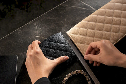 Hands measuring quilted leather bag panels