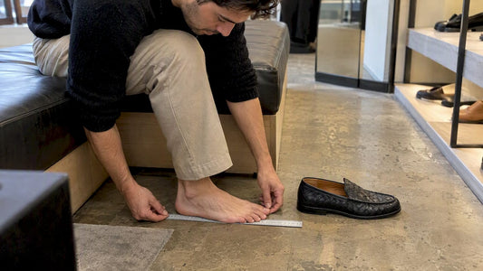 Foot measured beside a Bottega Veneta loafer