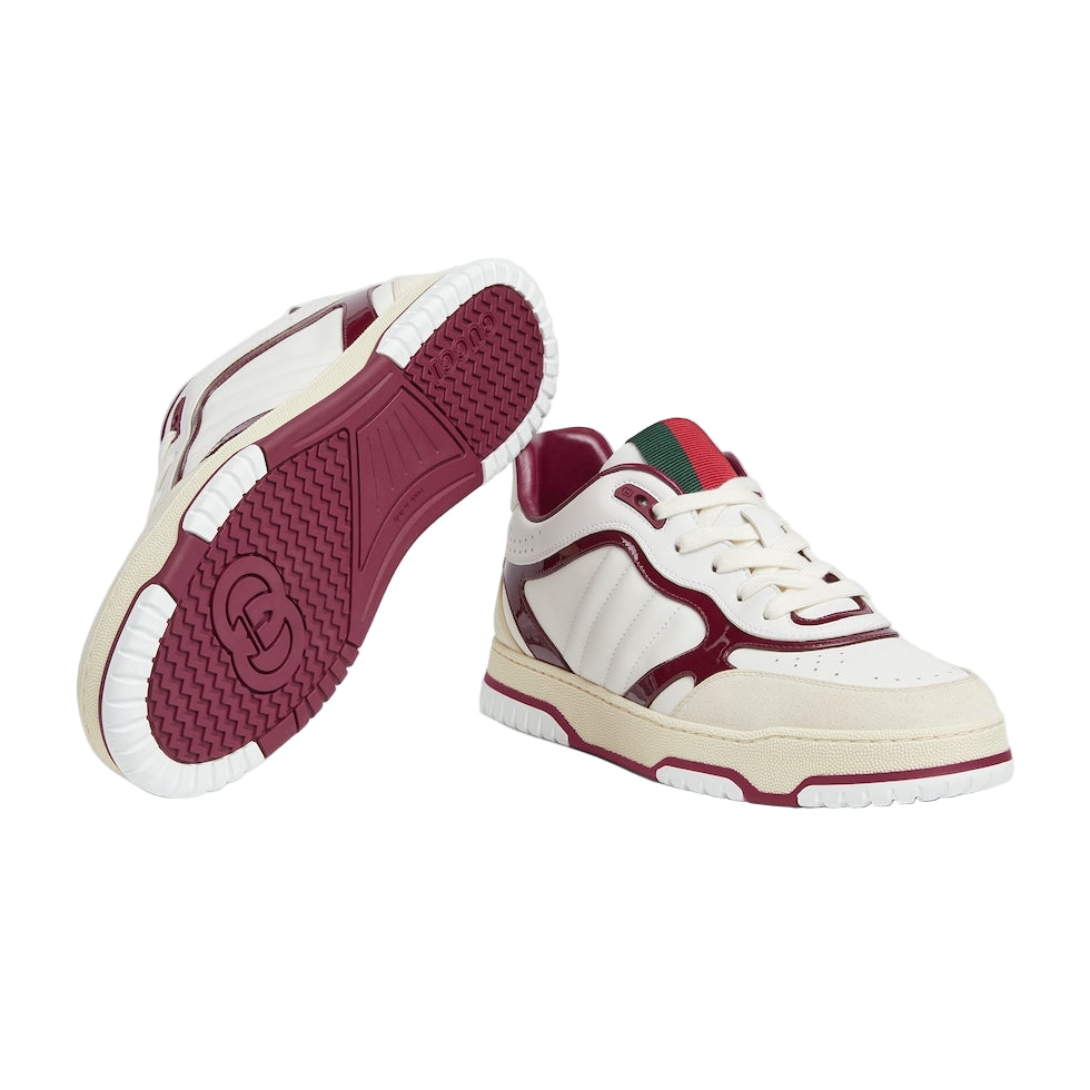 White and burgundy sneaker with a brand logo on a light gray background