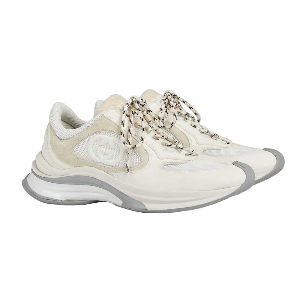 White sneaker with chain details on a light gray background