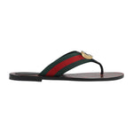 Flip-flop sandal with green and red striped strap on a light gray background