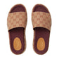 Pair of Gucci slides with brown pattern on a light gray background