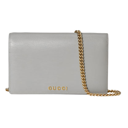 Gray handbag with gold chain and Gucci logo on a white background