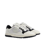 White and black sneakers with a brand logo on a light gray background