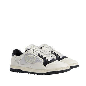 White and black sneakers with a brand logo on a light gray background