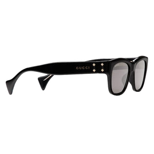Black Gucci sunglasses on a light gray background