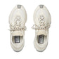 Pair of white sneakers with Gucci branding on a light gray background