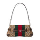 Designer handbag with distinctive pattern and colors on a light gray background