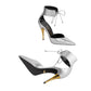 Silver high-heeled shoes with gold accents on a white background