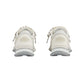 White sneakers with decorative elements on a light gray background