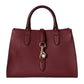 Burgundy handbag with a gold clasp on a light gray background