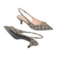 Pair of patterned slingback heels on a light gray background