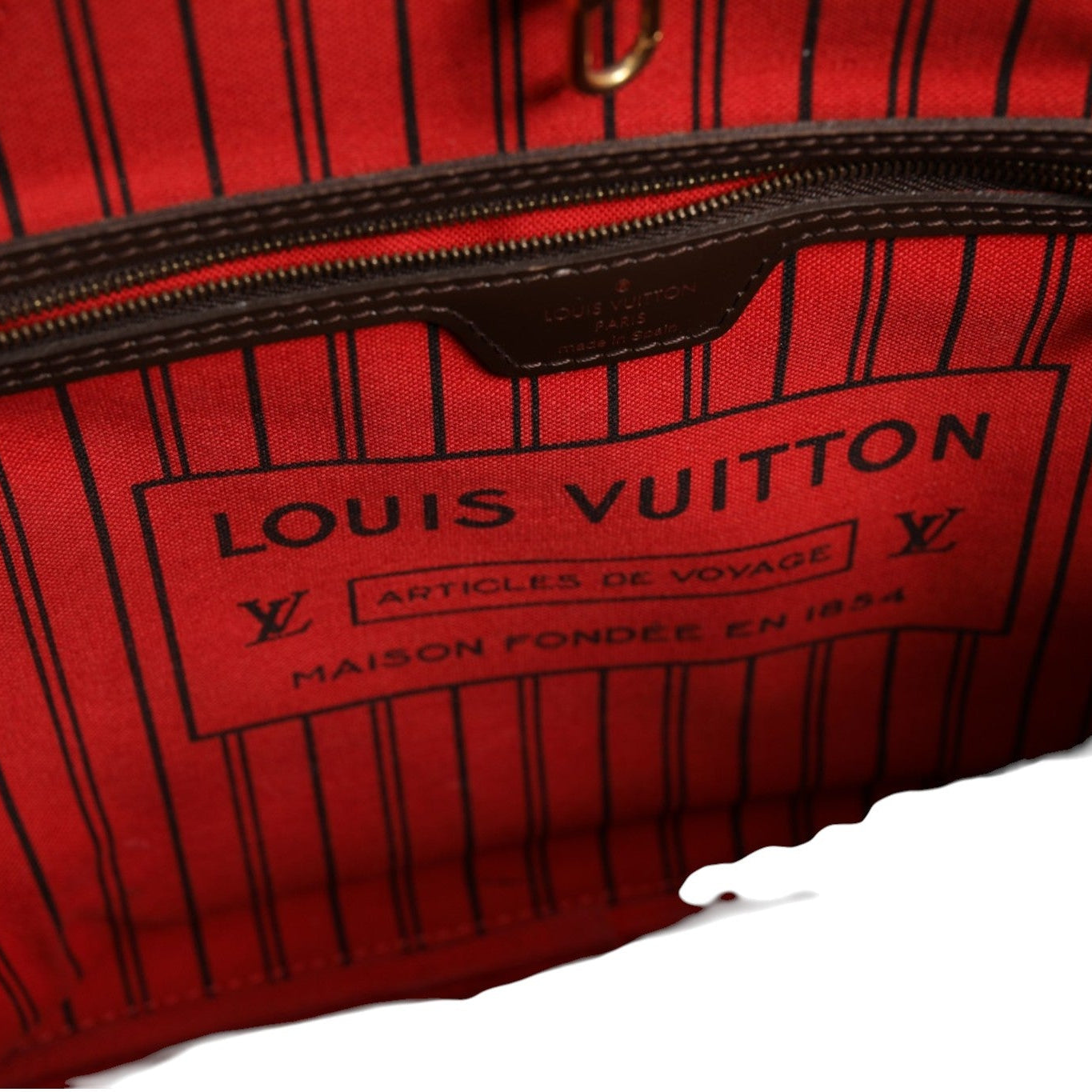 Red Louis Vuitton bag with visible branding on a white background