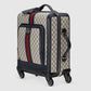 Designer suitcase with pattern and brand logo on a light gray background