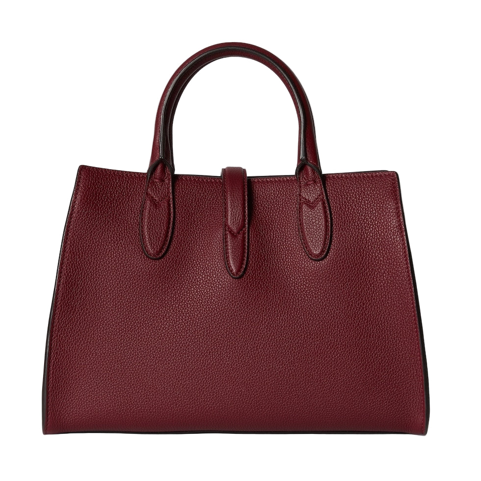 Burgundy leather handbag on a light gray background