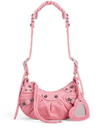 Pink handbag with heart-shaped tag on a white background