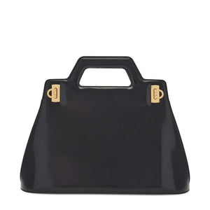 Black handbag with gold hardware on a white background