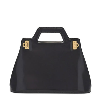 Black handbag with gold hardware on a white background