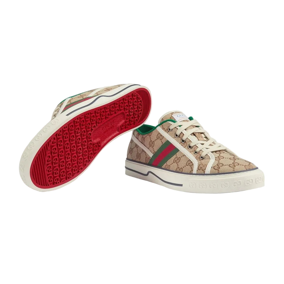 Beige sneakers with red and green accents on a light gray background