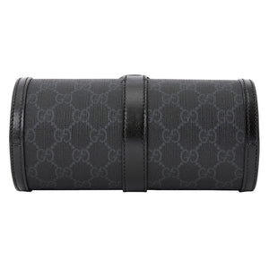 Black Gucci-patterned clutch bag on a light gray background