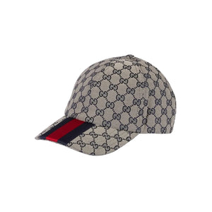 Beige cap with black pattern and red and blue striped band on a light gray background
