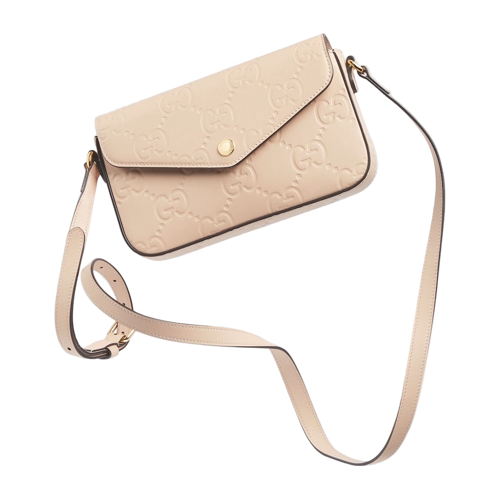 Beige handbag with a strap on a light gray background